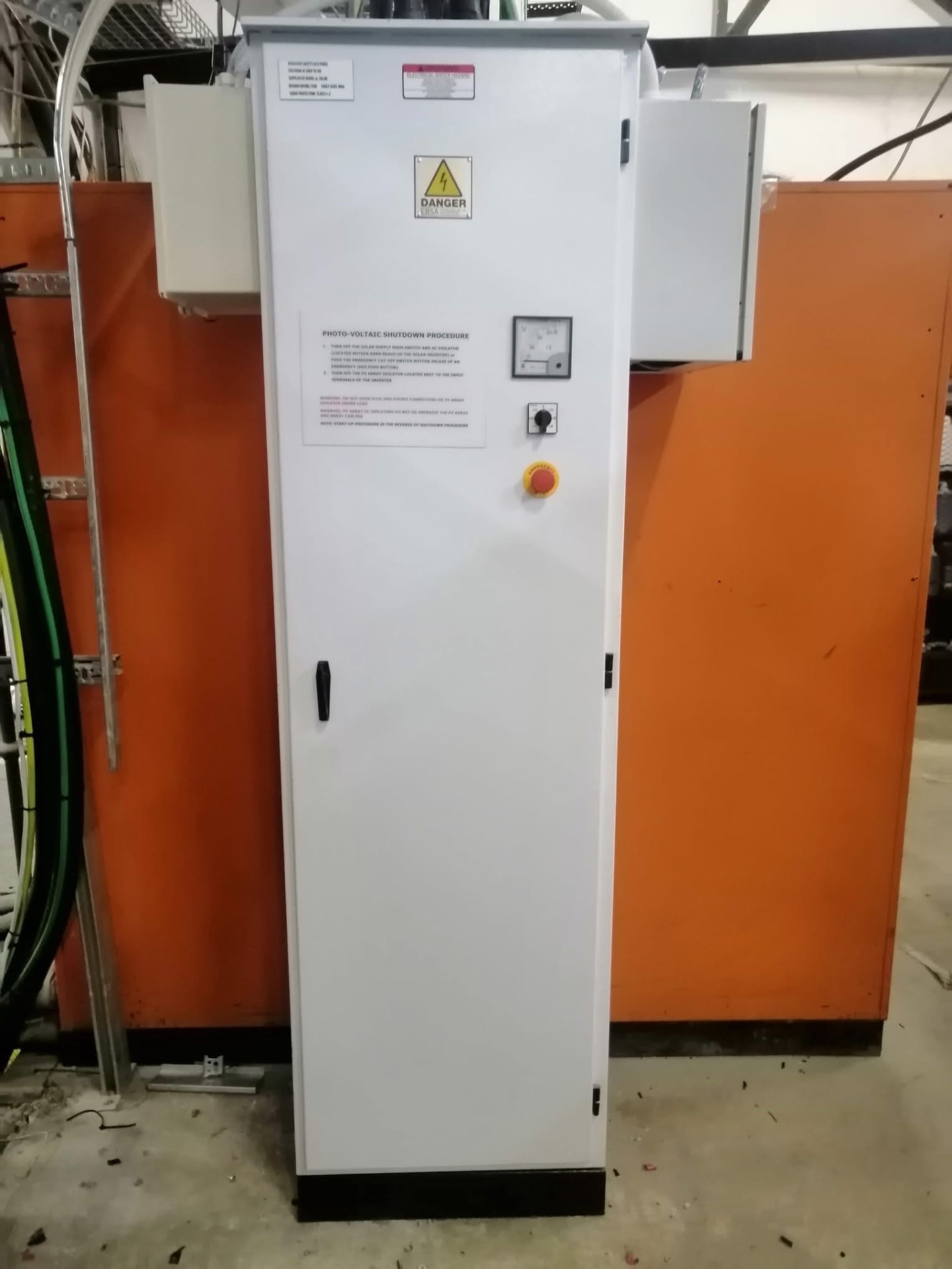 Photovoltaic main supply panel with shutdown procedure and emergency stop in an industrial plant room